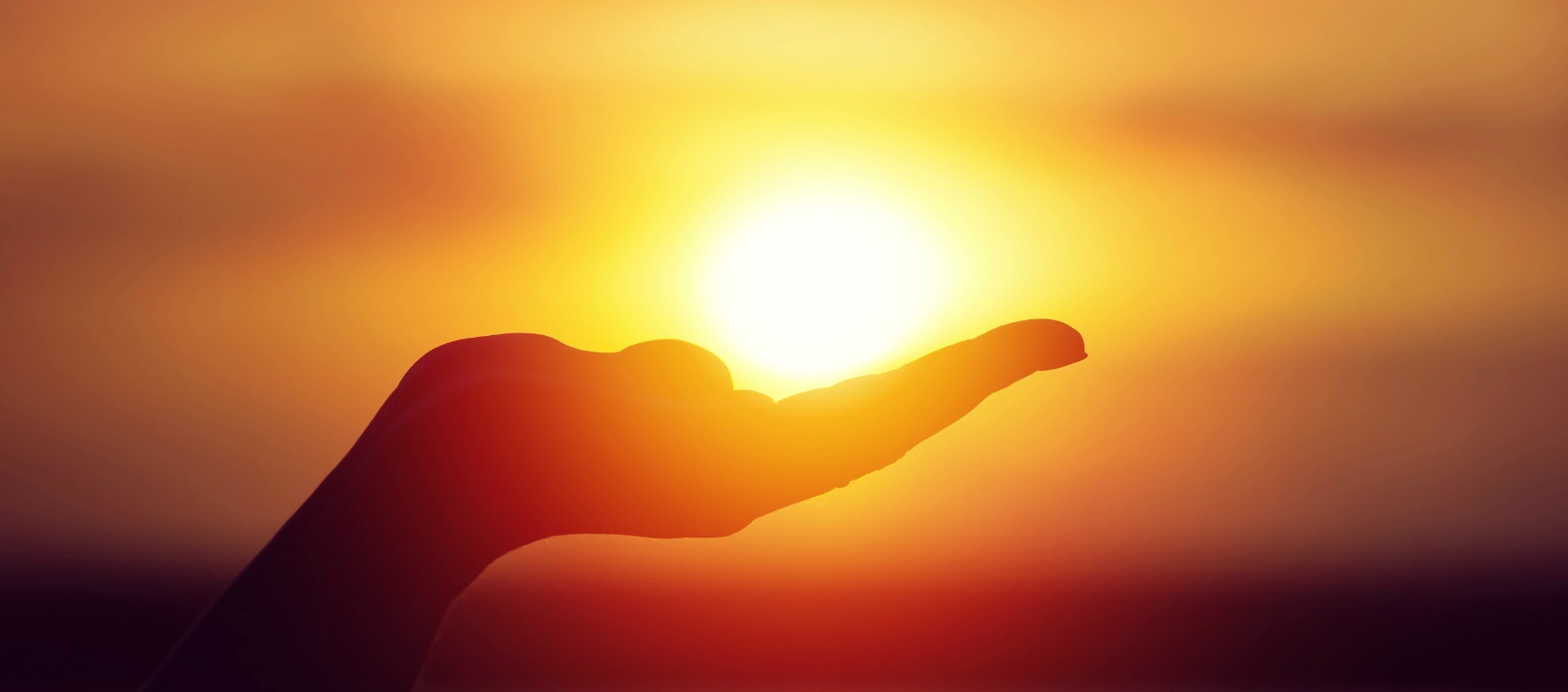 Sun on female hand. Silhouette of hand holding sun